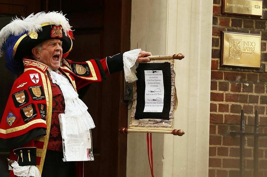 A ceremonial town crier holds a scroll after announcing the birth of a baby girl to royal fans and members of the media outside the entrance to the Lindo wing of St Mary's Hospital in London, Britain on&nbsp;May 2, 2015. The birth of Britain's royal 