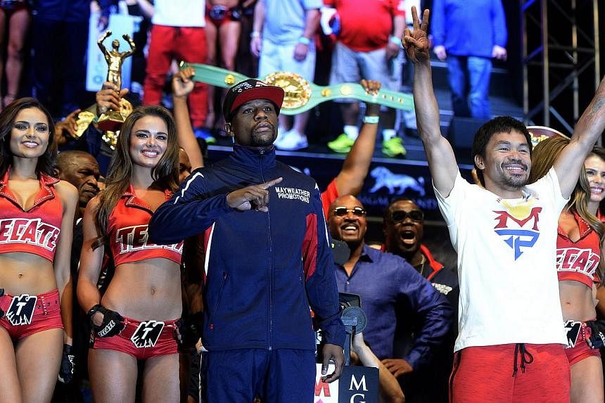 Filipino boxer Manny Pacquiao (right) and US boxer Floyd Mayweather Jr (left) posing together after their weigh-in at MGM Grand Garden Arena in Las Vegas on May 1, 2015. Pacquiao will fight Mayweather Jr. for the WBC welterweight title bout on May 2 