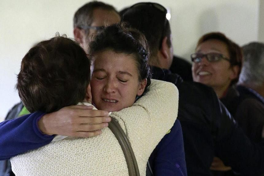 A relative embracing a Spaniard evacuated from Nepal at an air base outside of Madrid on April 28, 2015. 1,000 European Union citizens are still unaccounted for in Nepal, diplomats said, almost a week after a massive earthquake that has claimed more 