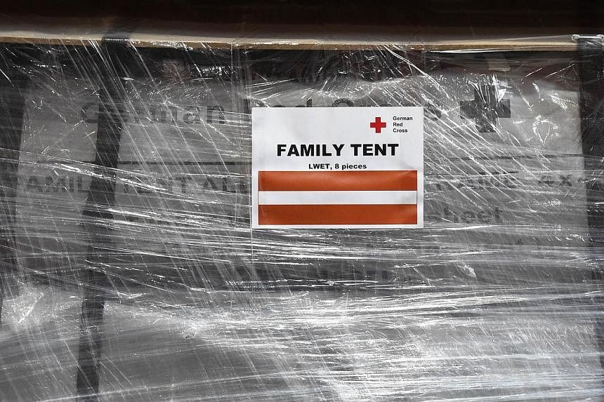 A wrapped family tent is seen at the logistics centre of the German Red Cross (DRK) at the Schoenefeld airport near Berlin, on April 27, 2015. Some of the relief goods were held up at Nepal's only international airport because of customs bottlenecks,