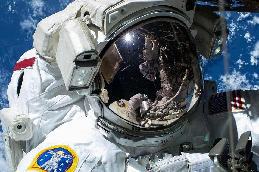 Nasa astronaut Barry "Butch" Wilmore is pictured as the Earth's surface passes by in the background on the International Space Station, in this handout photo taken Feb 21, 2015, provided by Nasa.&nbsp;Flying people to deep space - like Mars or an ast