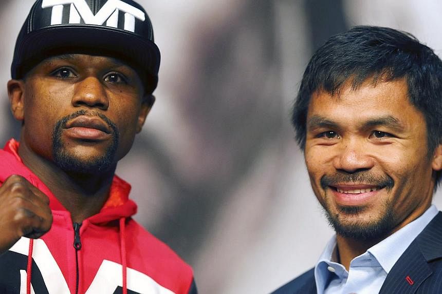 Floyd Mayweather (left) is a slight favourite, but Manny Pacquiao (right) is the people's choice according to the money being wagered on the Filipino icon ahead of Saturday's welterweight showdown. -- PHOTO: REUTERS