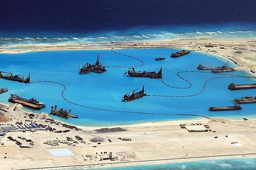 A handout picture made available by the Philippines armed forces on April 20, 2015 shows construction at Kagitingan (Fiery Cross) Reef in the disputed Spratley Islands in the South China Sea by China on Feb 18 2015. -- PHOTO: EPA
