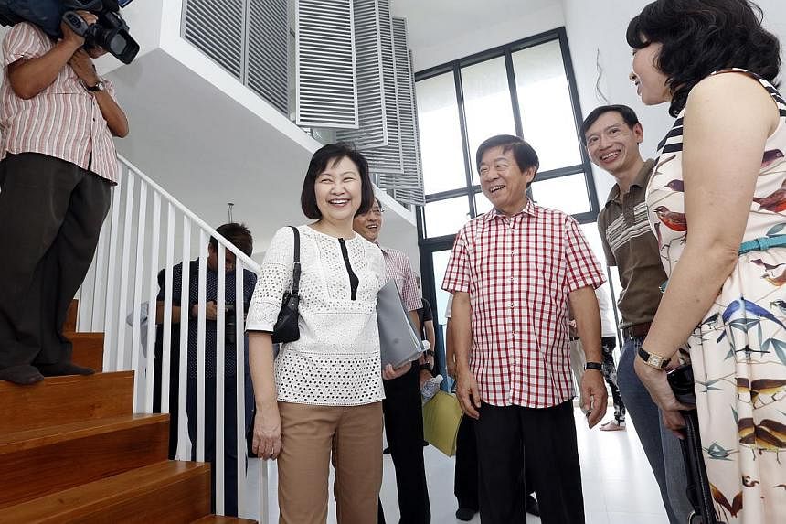 Minister for National Development, Mr Khaw Boon Wan meets new owners of a SkyTerrace@Dawson multi-generational loft unit, Mr Calvin Tang (second from right), a 48-year-old social worker, and wife Amy (right), a 45-year-old key account executive, duri