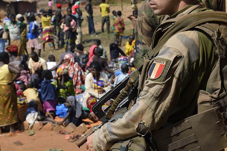 A file picture taken on Jan 19, 2014, shows a French soldier standing guard during an operation in Boali, some 100km north of Bangui. French prosecutors have opened an investigation into claims that French troops allegedly raped hungry children in ex