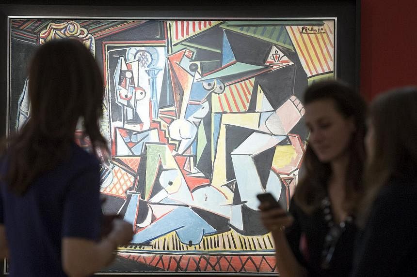 People look at Pablo Picasso's "Les femmes d'Alger (Version 'O')" (Women of Algiers), estimated at US$140 million, ahead of a preview event to Christie's upcoming impressionist, modern and contemporary art sale in Manhattan on May 1, 2015. -- PHOTO: 