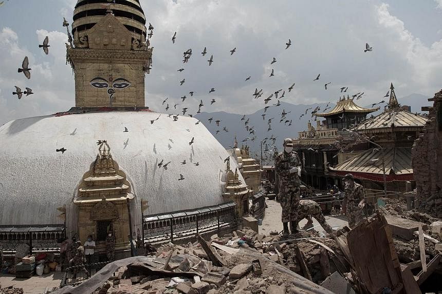 This picture taken on May 2, 2015, shows Nepalese soldiers clearing rubble of a building at the damaged Swayambhunath temple in Kathmandu, following a 7.8 magnitude earthquake which struck the Himalayan nation on April 25, 2015. -- PHOTO: AFP
