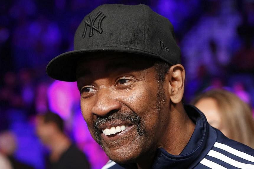 Actor Denzel Washington smiles as he sits ringside while waiting for the welterweight WBO, WBC and WBA (Super) title fight between Manny Pacquiao of the Philippines and Floyd Mayweather, Jr. of the U.S. in Las Vegas, Nevada, on May 2, 2015. -- PHOTO:
