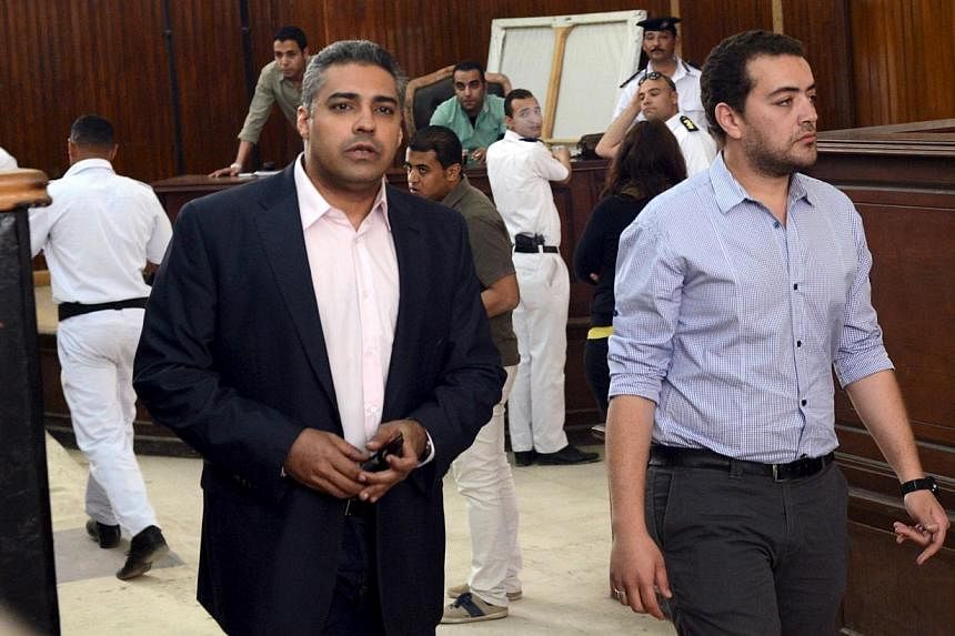Al-Jazeera television journalists Mohamed Fahmy (left) and Baher Mohamed are seen at a court in Cairo on April 22, 2015. They are undergoing a retrial after a court found procedural flaws in the original case. -- PHOTO: REUTERS&nbsp;