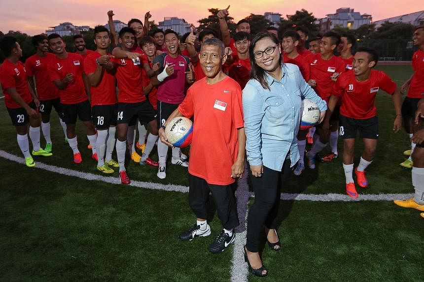 Kit man Zainol Abidin Omar, 56, and his daughter Nurul Jannah, 25, with the national Under-23 team. Mr Zainol was diagnosed with liver cancer last year but Ms Nurul donated 70 per cent of her liver to him. Now, he is back in action.