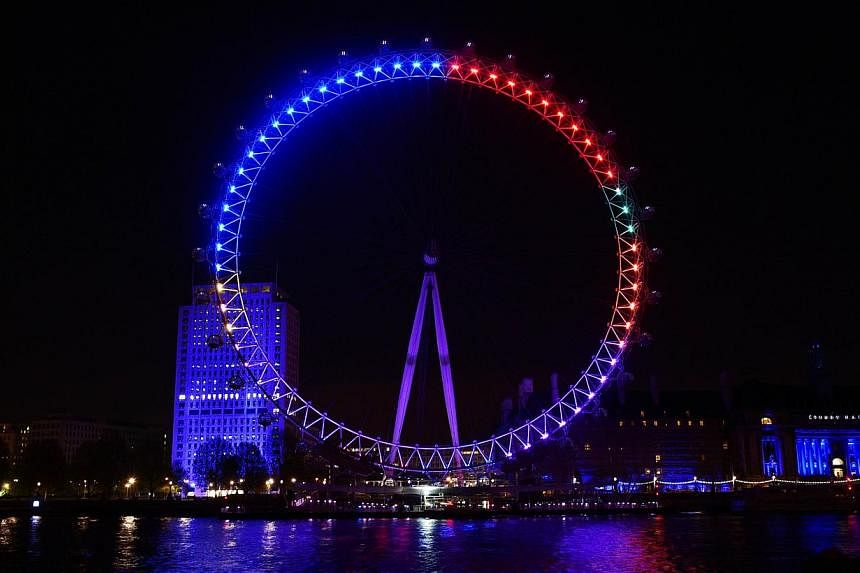 The London Eye overlooking the River Thames as seen on Friday, lit in colours that represent the different political parties vying for support in the British general election. The colours are meant to reflect how many interactions each party chalks u