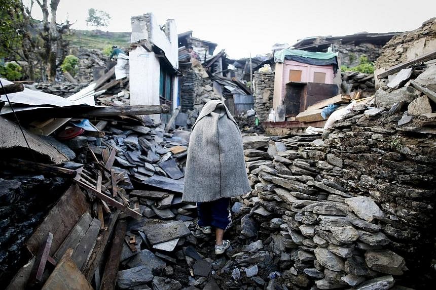 A man walks through what is left from Barpak village, Gorkha district, epicentre of the devastating earthquake that hit the country on April 25, 2015. -- PHOTO: EPA&nbsp;
