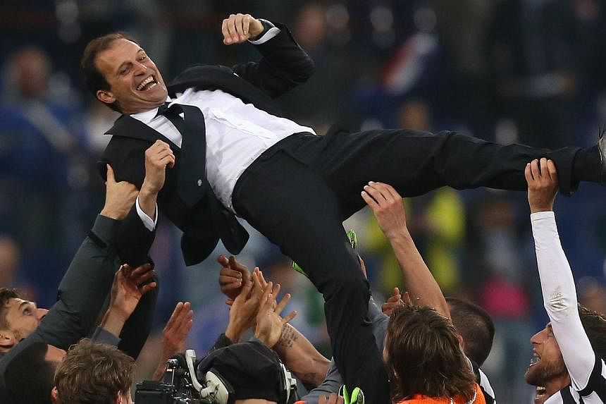 Juventus' players celebrate with their coach Massimiliano Allegri after winning&nbsp;the Italian title for the 31st time on Saturday. -- PHOTO: AFP&nbsp;