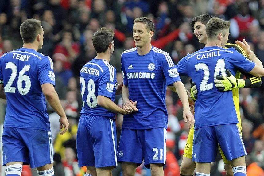 Chelsea players celebrate at the end of the English Premier League match against Arsenal at The Emirates Stadium, in London, on April 26, 2015. Chelsea only need to get three more points for them to win the EPL crown. -- PHOTO: EPA