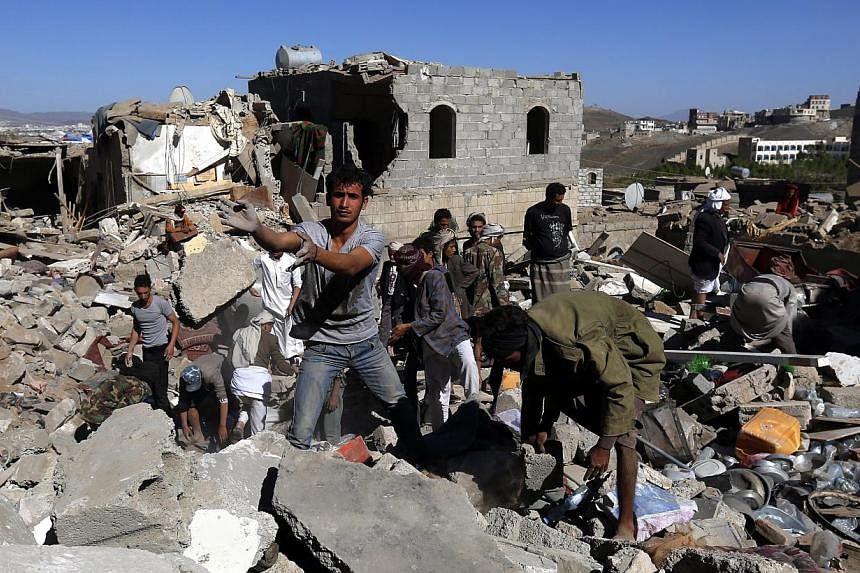 Yemenis inspecting houses which were allegedly destroyed by an air strike of the Saudi-led coalition targeting Houthi rebels’ nearby positions in Sana’a, Yemen, on May 1, 2015. Rights group Human Rights Watch accused the Saudi-led coalition of us