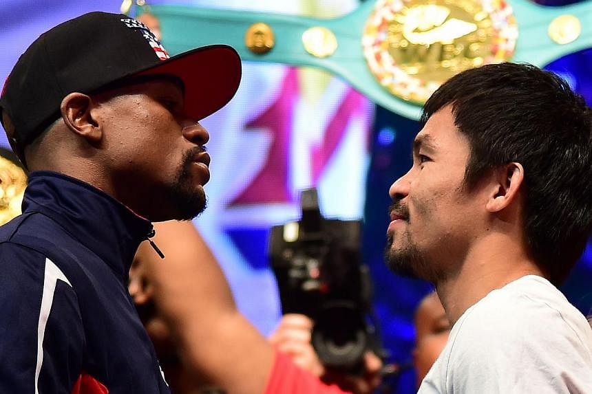 Floyd Mayweather and Manny Pacquiao face off following their weigh-in on May 1, 2015, in Las Vegas, Nevada one day before their "Fight of the Century" on May 2 at the MGM Grand Garden Arena. -- PHOTO: AFP&nbsp;