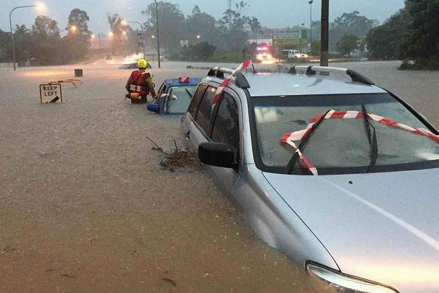 Swift water operators assessing vehicles submerged in floodwaters in Brisbane, Australia, on May 1, 2015.&nbsp;The death toll from heavy rains that inundated Australia's east coast has climbed to six, as flood warnings continued Sunday following a se
