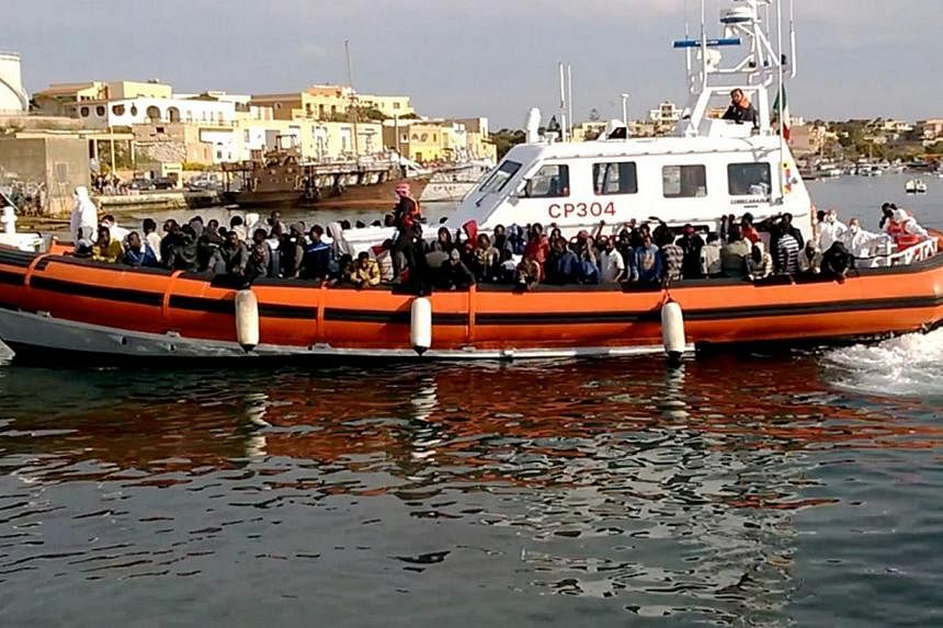 An Italian coast guard ship transporting migrants arriving in Lampedusa harbour on May 1, 2015.&nbsp;Italy's coast guard attempted to rescue more migrants in the Mediterranean on Sunday, May 3, after nearly 3,700 were picked up trying to reach Europe