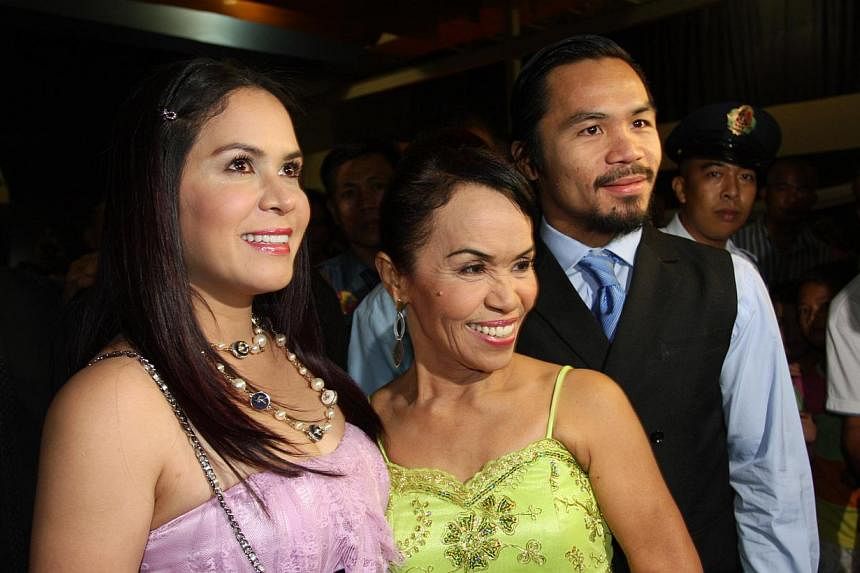 (From right) World welterweight boxing champion Manny Pacquiao is seen with his mother Dionisia Pacquiao and wife Jinkee Pacquiao at the KCC Mall on May 15, 2010 in General Santos, Philippines. -- PHOTO:&nbsp;GETTY IMAGES
