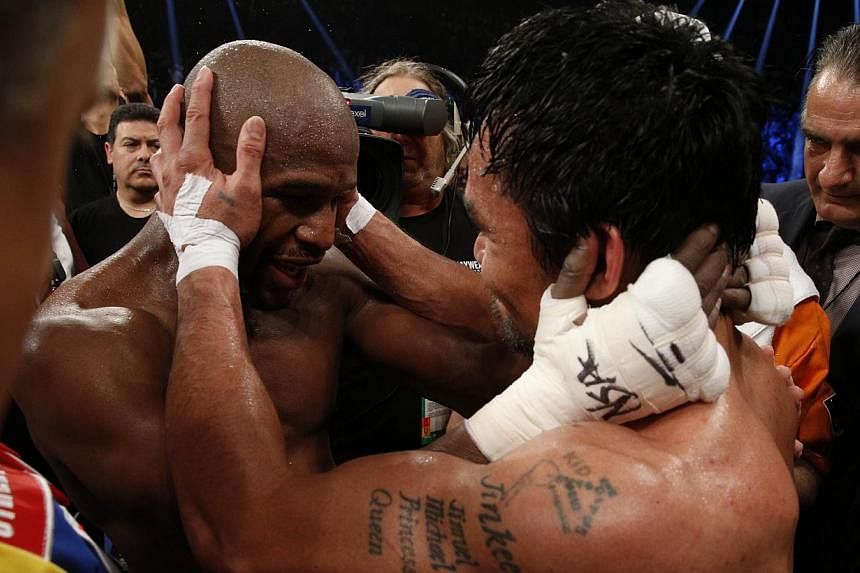 Floyd Mayweather Jr. hugs Manny Pacquiao after defeating Pacquiao in their welterweight unification bout on May 2, 2015 at the MGM Grand Garden Arena in Las Vegas, Nevada.&nbsp;-- PHOTO: AFP