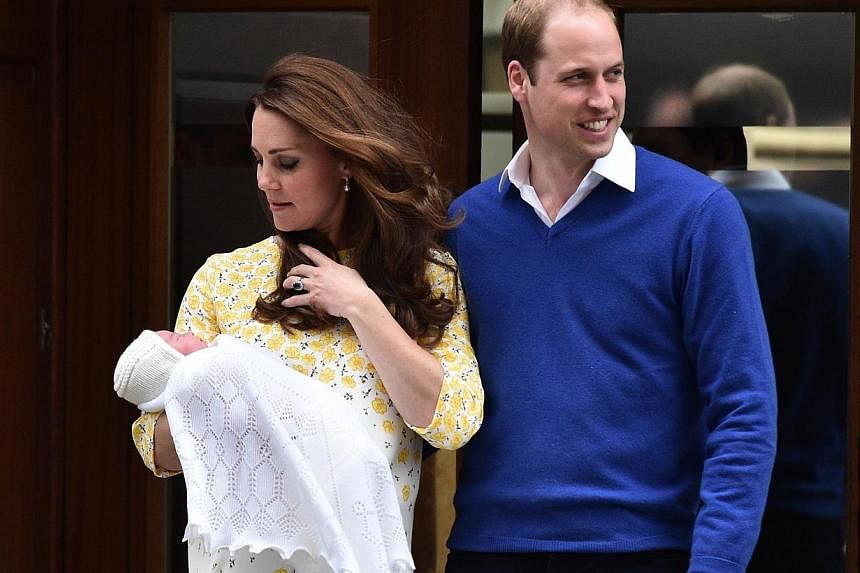 Britain's Prince William, Duke of Cambridge, and his wife Catherine, Duchess of Cambridge show their newly-born daughter, their second child, to the media outside the Lindo Wing at St Mary's Hospital in central London, on May 2, 2015. -- PHOTO: AFP