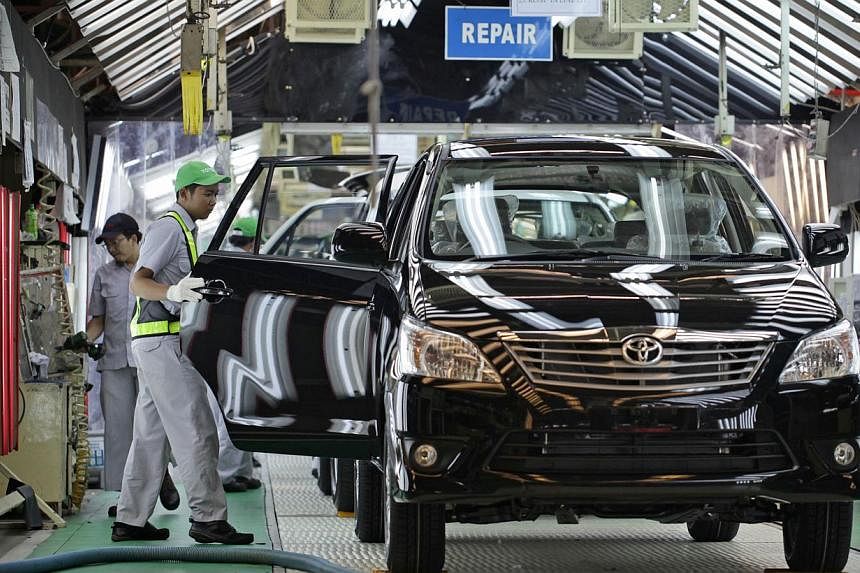 A worker makes a final check on a Toyota Motor Corp. Kijang Innova minivan on the production line of PT. Toyota Motor Manufacturing Indonesia's (TMMIN) Karawang plant in Karawang, West Java, Indonesia. -- PHOTO: BLOOMBERG&nbsp;