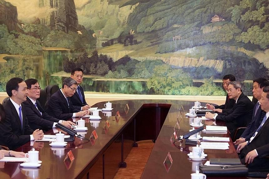 A handout photo released by Taiwan's ruling party the Chinese Nationalist Party (Kuomintang or KMT), shows Chinese President Xi Jinping (right), in his capacity as secretary-general of the Chinese Communist Party, meeting with KMT Chairman Eric Chu (