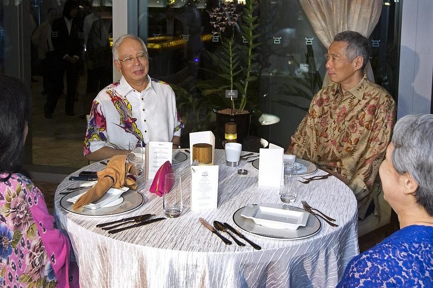Prime Minister Lee Hsien Loong and his wife Ho Ching hosted Malaysian Prime Minister Najib Razak and his wife Rosmah Mansor to a private dinner on Monday night at Sentosa Cove. -- PHOTO: MINISTRY OF COMMUNICATION AND INFORMATION