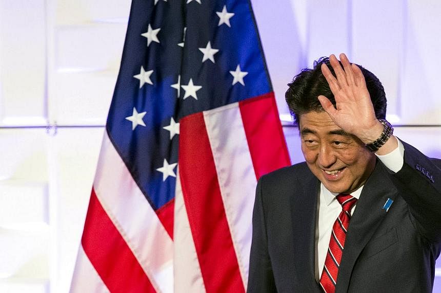 Japan's Prime Minister Shinzo Abe waves after speaking at a luncheon at the Japan-US Economy Forum in Los Angeles, California, on May 1, 2015. South Korean President Park Geun Hye said Mr Abe missed an opportunity to improve ties between their countr