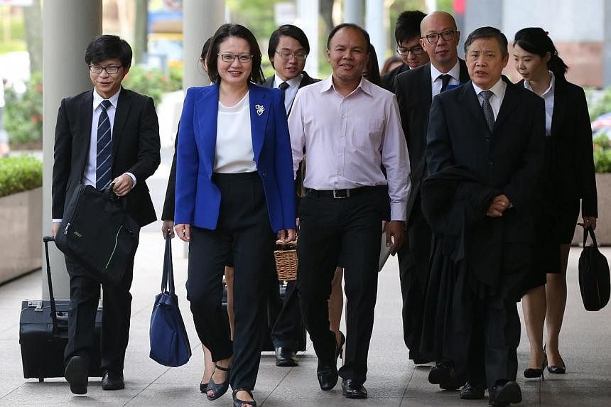 Sylvia Lim (in blue) and Muhamad Faisal Manap (centre) arriving at the High Court on May 4, 2015. The Ministry of National Development (MND) on Monday cited Aljunied-Hougang-Punggol East Town Council (AHPETC) chairman Sylvia Lim saying that the town 
