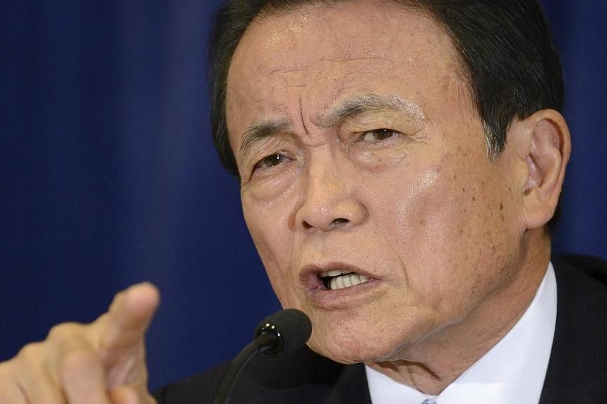 Japan's Finance Minister and Deputy Prime Minister Taro Aso makes remarks during a news conference in Washington last month. -- PHOTO: &nbsp;REUTERS