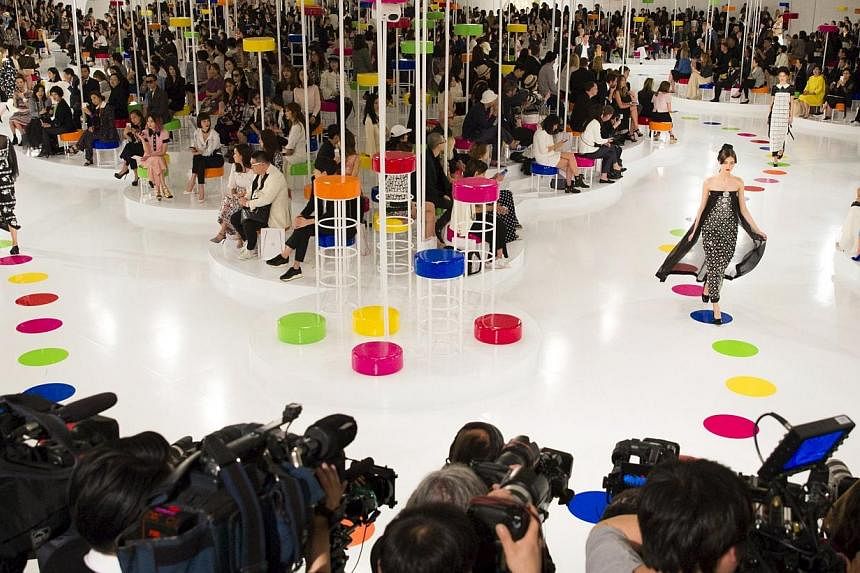 Models present creations of the Chanel Cruise Collection 2015/16 at the Dongdaemun Design Plaza in Seoul on Monday. French fashion house Chanel looked to traditional South Korean dress for its cruise collection, unveiling a colourful inter-seasonal l