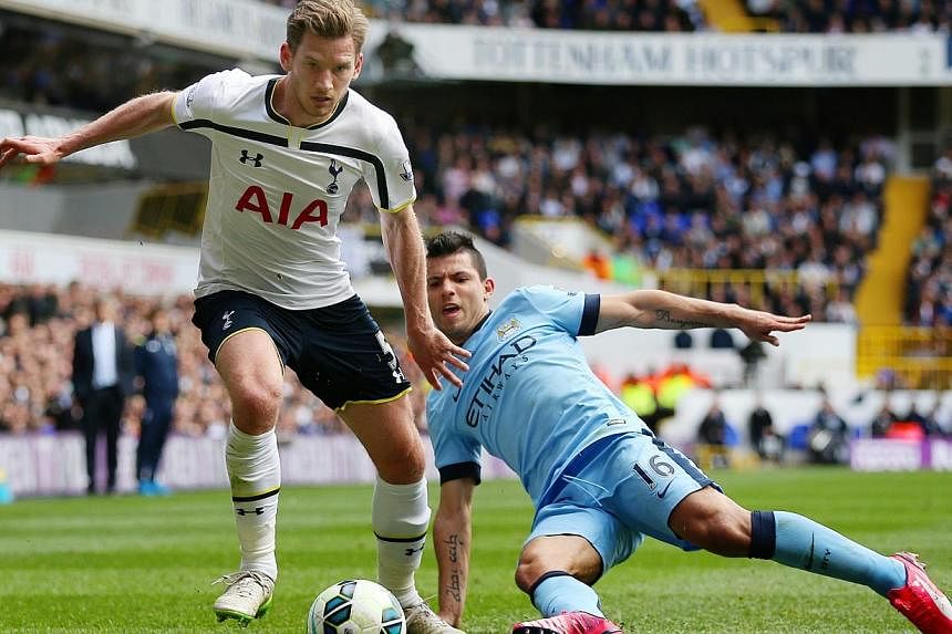 Tottenham's Jan Vertonghen in action with Manchester City's Sergio Aguero on Sunday. -- PHOTO: REUTERS