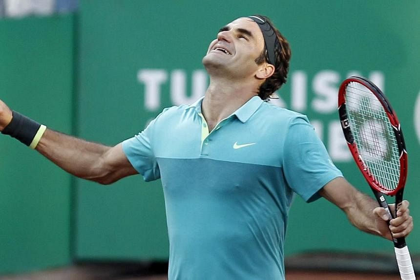 Roger Federer of Switzerland celebrates after winning Pablo Cuevas of Uruguay during the final match at the TEB BNP Paribas Istanbul Open tennis Tournament in Istanbul, Turkey on Sunday.-- PHOTO: EPA