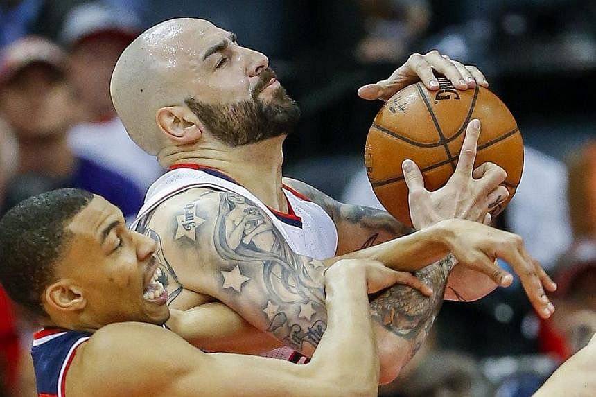 Washington Wizards forward Otto Porter Jr. (left) and Atlanta Hawks forward Pero Antic (right) of Macedonia battle for a rebound during the second half of game one of the NBA Eastern Conference semifinal round series between the Washington Wizards an