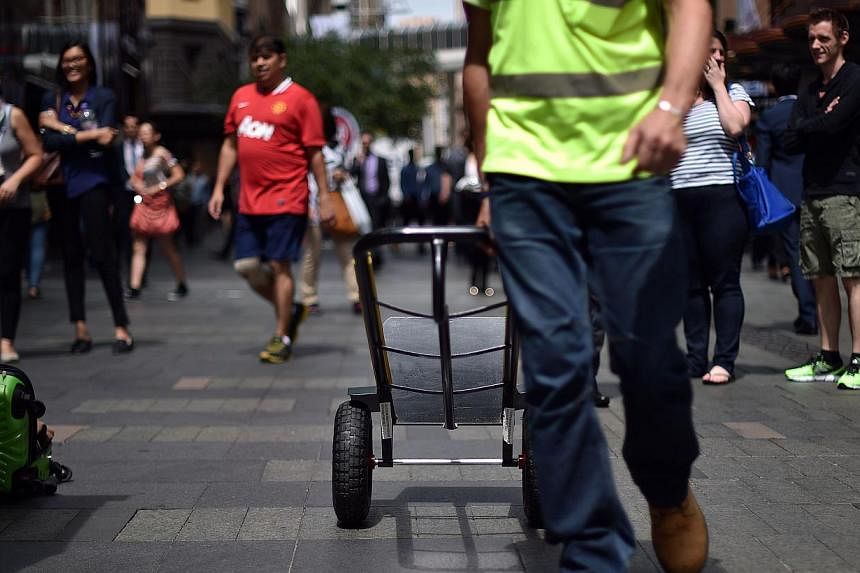 A worker returning after making a delivery in the Sydney Central Business District on March 4, 2015. An Australian state government said on Tuesday it would hold an inquiry into the exploitation of migrant workers after a television investigation rev