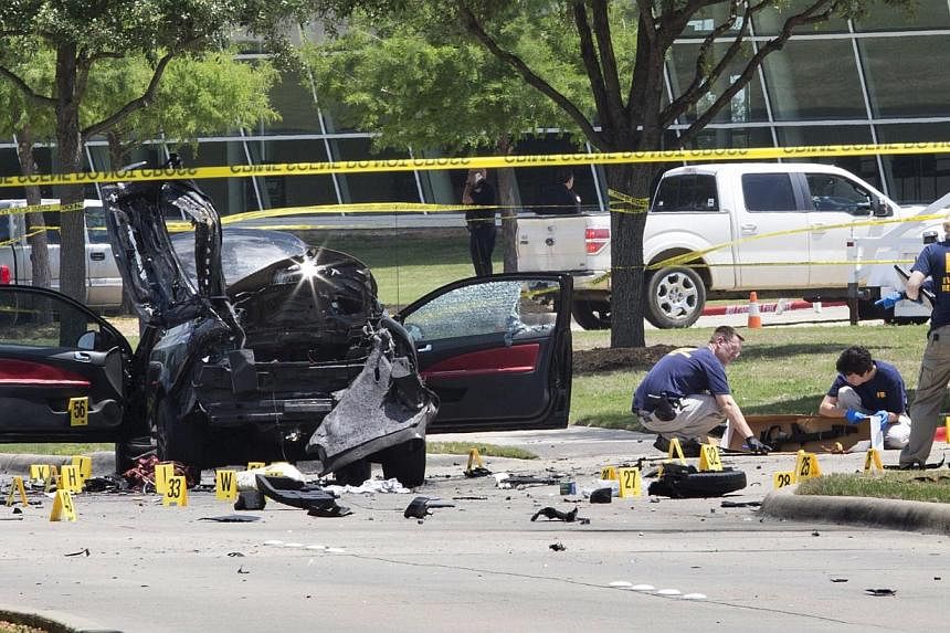 Local police and FBI investigators collect evidence where two gunmen, who opened fire on Sunday outside an exhibit of caricatures of the Prophet Muhammad, were shot dead in Garland, Texas on May 4, 2015. -- PHOTO: REUTERS