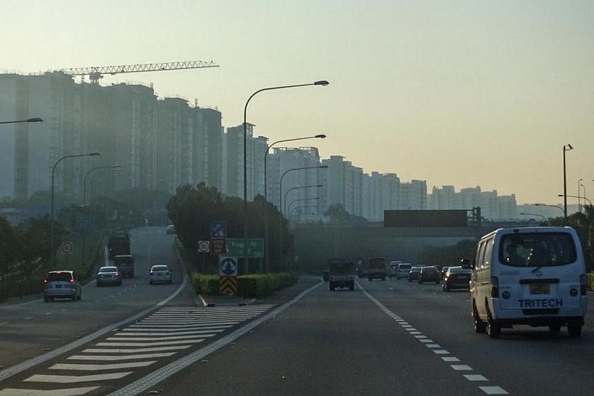 A slightly hazy skyline along the Tampines Expressway (TPE) with Punggol housing estate in the background taken at 7.20am on Tuesday, May 5, 2015. -- ST PHOTO: STEPHANIE YEOW