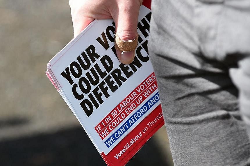 A Labour Party activist canvassing houses in Eastham, north-west England, on May 3, 2015. Britain goes to the polls on May 7. -- PHOTO: AFP&nbsp;