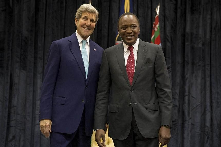 US Secretary of State John Kerry (left) poses for a photograph with Kenyan President Uhuru Kenyatta at the State House, in Nairobi, on May 4, 2015. -- PHOTO: AFP