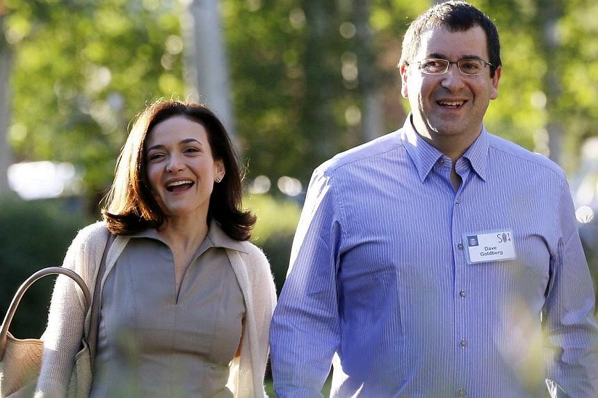Sheryl Sandberg, (left), Chief Operating Officer (COO) of Facebook, arriving with her husband David Goldberg, CEO of SurveyMonkey, for the first day of the Allen and Co. media conference in Sun Valley, Idaho on July 9, 2014. Goldberg died Friday from