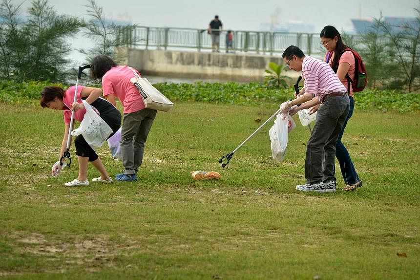 Volunteers picking up litter at East Coast Park. -- PHOTO: ST FILE&nbsp;
