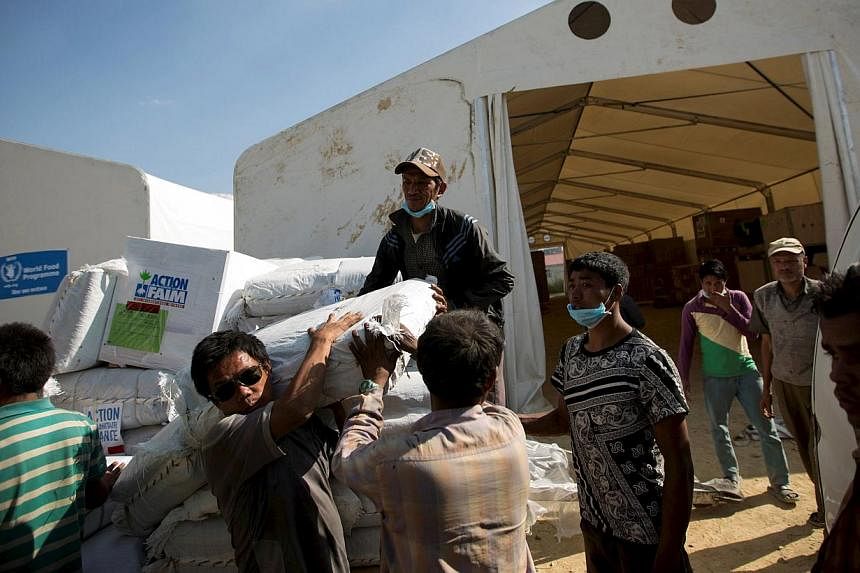 Workers loading relief material onto a truck for earthquake victims at the cargo terminal of international airport in Kathmandu, Nepal on May 3, 2015. -- PHOTO: REUTERS