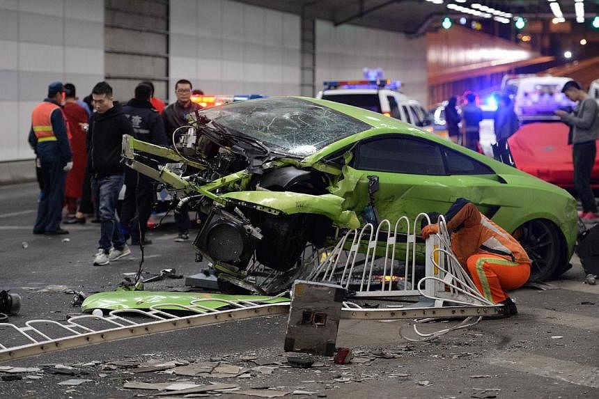 This photo taken early on April 12, 2015 shows a badly damaged Lamborghini car and debris in a tunnel after a crash involving a Ferrari in Beijing. -- PHOTO: AFP