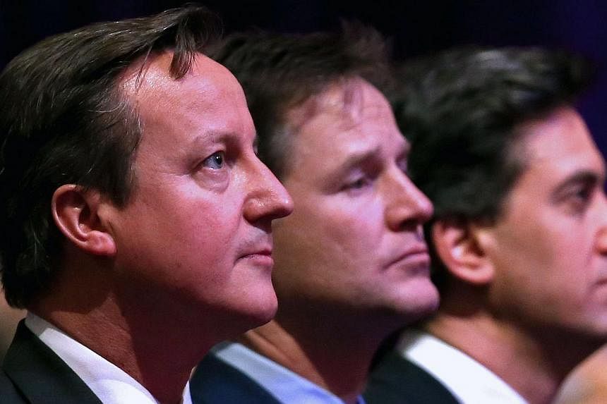 Britain's Prime Minister David Cameron (left), British Deputy Prime Minister Nick Clegg (centre) and leader of the opposition Labour Party Ed Miliband (right) attend a Holocaust Memorial Day ceremony at Central Hall Westminster in London on Jan 27, 2
