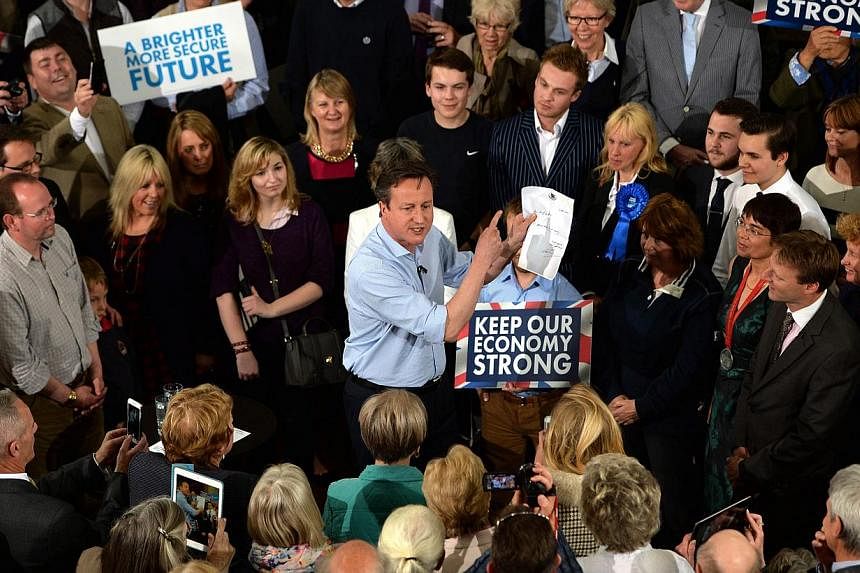 British Prime Minister David Cameron (centre) campaigns at a rally in St Ives, Cornwall, as part of his 36 hour non-stop tour of the UK, Britain, on May 5, 2015. -- PHOTO: EPA&nbsp;