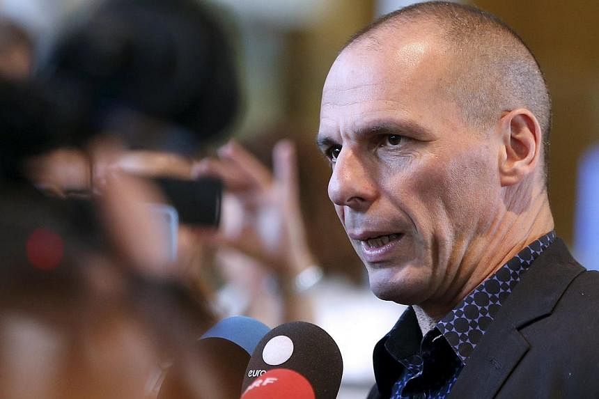 Greek Finance Minister Yanis Varoufakis talking to reporters while leaving the European Commission headquarters in Brussels on May 5, 2015. -- PHOTO: REUTERS