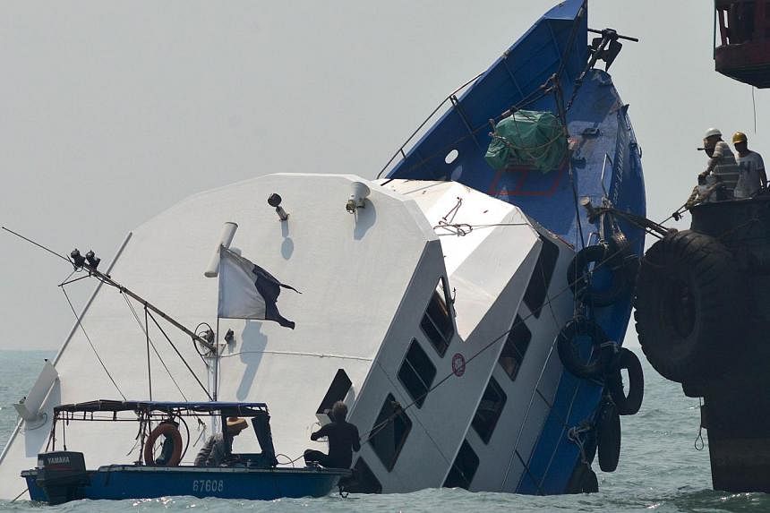 This file picture taken on Oct 2, 2012 shows the bow of the Lamma IV boat partially submerged during rescue operations the morning after it collided with a Hong Kong ferry. Two Hong Kong government officials charged over the city's worst maritime dis