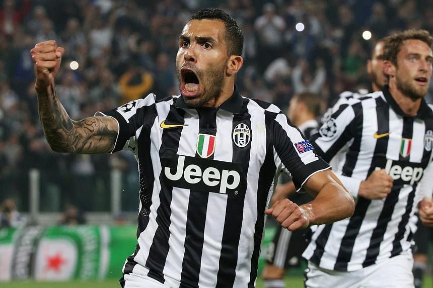 Juventus striker Carlos Tevez celebrates scoring his team's second goal from the penalty spot in their 2-1 Champions League semi-final first-leg win over Real Madrid in Turin. -- PHOTO: REUTERS
