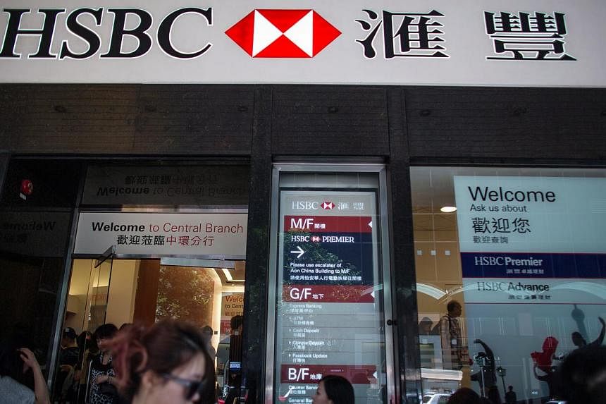 Pedestrians walking past a HSBC Holdings branch in Hong Kong on May 4, 2015. China's services sector grew at its fastest pace this year in April as a sizzling stock market rally helped boost consumer confidence and spending, a private survey showed o